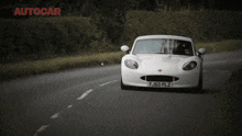 a white sports car with the license plate yj60 plz
