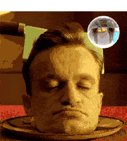 a man 's head is sitting on a plate with a knife in it