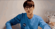a young man wearing glasses and a blue sweatshirt with the word monkey on it