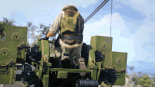 a man in a green vest is standing on a green vehicle