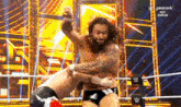 two men are wrestling in a wrestling ring on peacock .