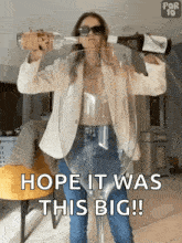 a woman is pouring a bottle of wine into a giant wine glass that says hope it was this big !
