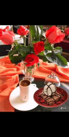a cup of coffee and a plate of brownies on a table