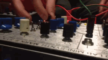 a person is playing a minisynth mars device