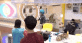 a group of people are standing around a table with pots and pans on it .