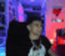a blurry picture of a man sitting in a chair in front of a microphone .