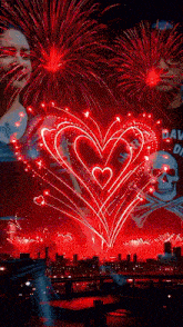 a heart shaped fireworks display with a skull in the background