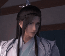 a man with long black hair is wearing a kimono