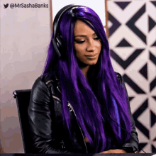 a woman with purple hair is wearing headphones and a black leather jacket