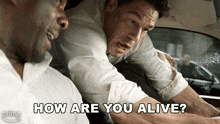 two men in a car with the words how are you alive on the bottom