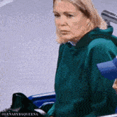 a woman wearing a green hoodie with the name lenarybaqueena on the bottom