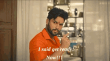 a man in an orange shirt says " i said get ready now !! "