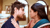 a man and a woman are kissing and the woman is wearing a wedding ring