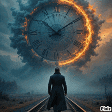 a man is walking on train tracks in front of a clock that says xii