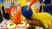 a person is holding a stuffed animal in front of a sign that says " 063 "