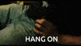 a man 's arm is shown with the words hang on behind it