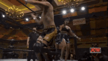 a wrestler in a ring with a sign that says snowbury on it