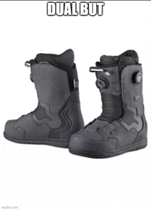a pair of black snowboard boots with the words dual but on the bottom