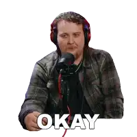 a man wearing headphones and a plaid shirt says " okay "
