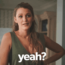 a woman in a green dress is asking the question " yeah "