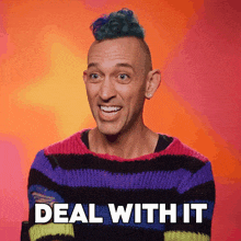 a man with a mohawk is wearing a striped sweater and says deal with it