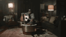 a man is playing a guitar in a dark room