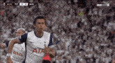 a soccer player wearing a white jersey with aia on it