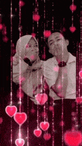 a man and a woman are standing next to each other with hearts falling from the sky