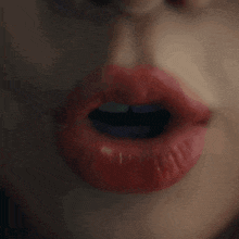 a close up of a woman 's lips with red lipstick on