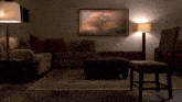 a living room with a picture on the wall above the couch