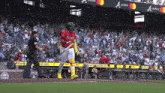 a baseball player in a red uniform with the word braves on the back