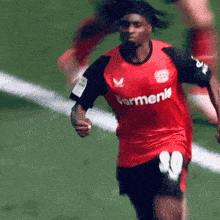 a soccer player wearing a red shirt that says parmenk on it
