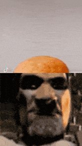 a close up of a man 's face with sunglasses and a hamburger in the background