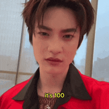 a young man in a red jacket says it 's 100 in yellow letters