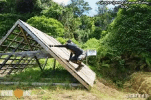 a man is climbing up a wooden wall with the words apache race written on it