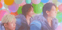 a group of people are standing in front of colorful balloons with the words number 1 on the top