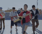 a man in a red jacket is holding a trumpet