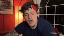 a man with a bandana on his head has a gif run.com watermark on the bottom right