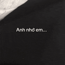 a black background with the words anh nho em written in white
