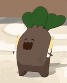 a cartoon character with a green leaf on its head is standing on a sandy surface .
