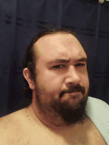 a man with a beard is laying on a towel