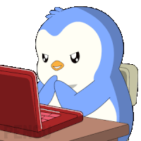 a blue penguin is sitting at a desk using a laptop