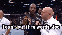 a man holding a ufc championship belt talks to a reporter