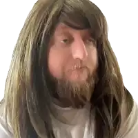 a man with long hair and a beard is looking at the camera