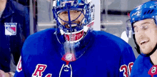 a hockey player wearing a blue jersey with the letter r on the front