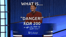 a man stands at a podium with the words " danger for 200 " written on it