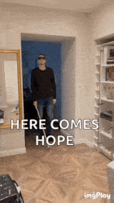 a man walking with a cane in a hallway with the words here comes hope on the bottom