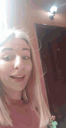 a woman is taking a selfie with her mouth open