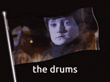 a flag with a picture of a boy and the words the drums on it
