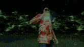 a man in a hawaiian shirt is surrounded by green flames
